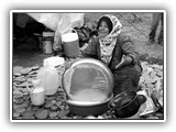 Refugee Woman Washes Tray